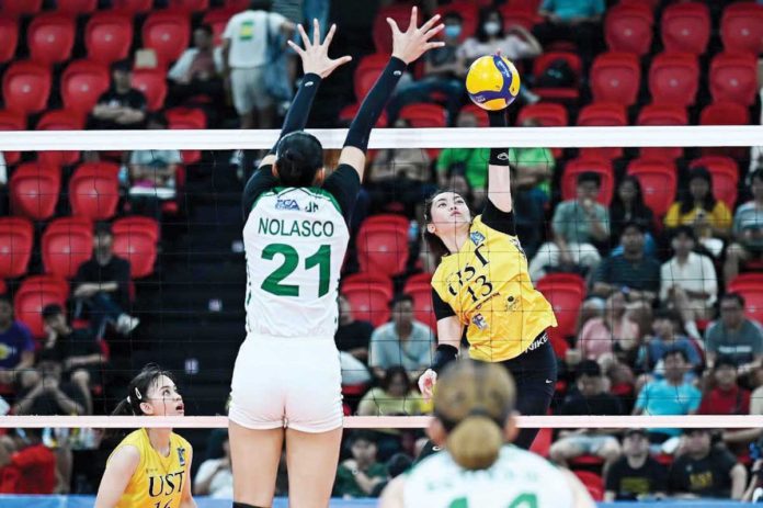 University of Santo Tomas Golden Tigresses’ Jonna Perdido scores against the defense of College of St. Benilde Lady Blazers’ Samantha Nolasco. PHOTO COURTESY OF V-LEAGUE