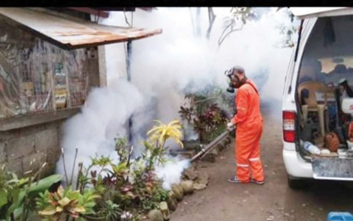 A staff of the Bacolod City Health Office conducts fogging in one of the villages with reported dengue cases in this undated photo. BACOLOD CITY PIO PHOTO