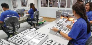 Staff workers operate a hot-foil printing machine as they produce plate numbers at the Land Transportation Office plate-making plant/assembly line in its headquarters in Quezon City. JONATHAN CELLONA/ABS-CBN NEWS PHOTO