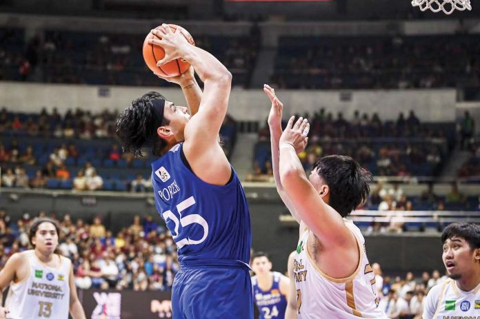 Ateneo de Manila University Blue Eagles’ Kristian Porter pulls up for a shot against a National University Bulldogs’ defender. UAAP PHOTO