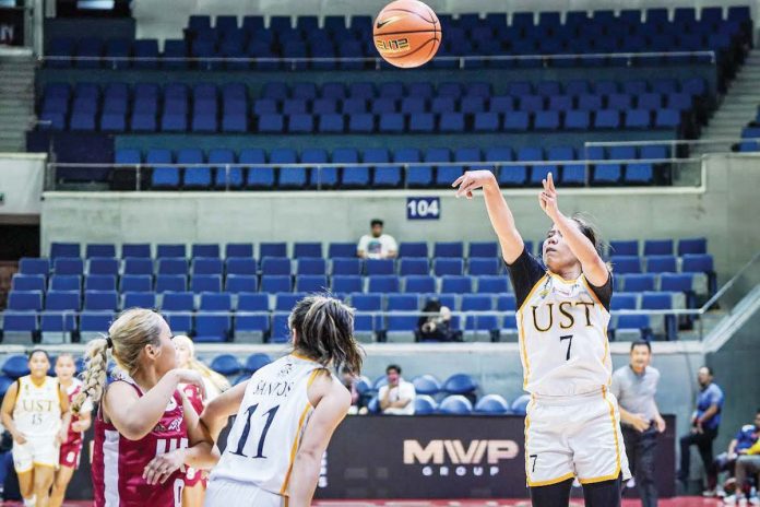 Ilongga Ana Tacatac of the University of Santo Tomas Growling Tigresses attempts a three-point shot. UAAP PHOTO