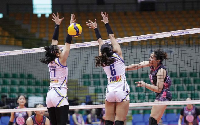 Negrense Erika Jin Deloria of Biñan Tatak Gel 1-Pacman Partylist Volley Angels smashes the ball against the two Negros-ICC Blue Hawks defenders. MPVA PHOTO