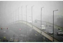 Commuters drive amid dense smog in New Delhi, India. AFP