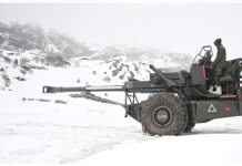 An Indian army soldier sits on a mobile artilery unit in the snow in the Himalayan mountains. Ties between India and China have been strained since the 2020 clashes along a disputed border. AFP