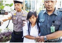 This 2015 photo shows a handcuffed Mary Jane Veloso being escorted by two Indonesian policemen. She faced drug charges. PHOTO FROM WIC.ORG