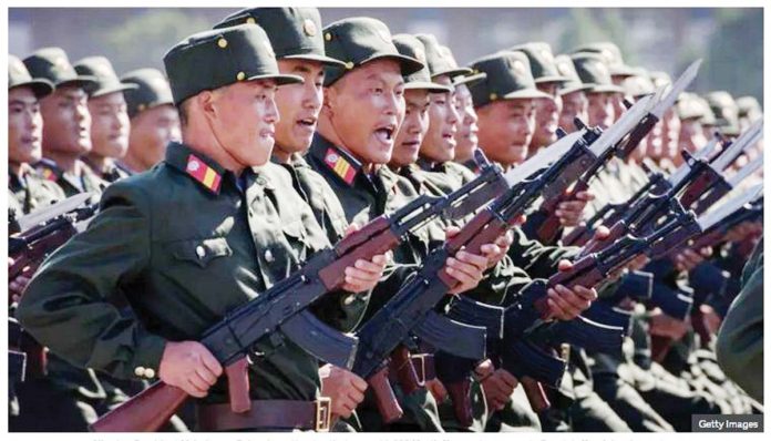 North Korean soldiers march during a mass rally. GETTY IMAGES