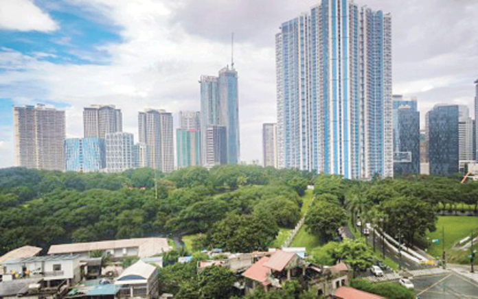 The skyline and business district of Bonifacio Global City in Taguig City are photographed on a clear Friday afternoon on Oct. 4, 2024. S&P Global Ratings said on Tuesday, Nov. 26, 2024, raised the Philippine credit ratings outlook to positive, citing the country's strong growth economic potential. PNA PHOTO BY JOAN BONDOC