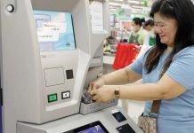 A woman deposited coins in a coin deposit machine in Metro Manila. The coins were directly credited to her electronic wallet. BSP PHOTO