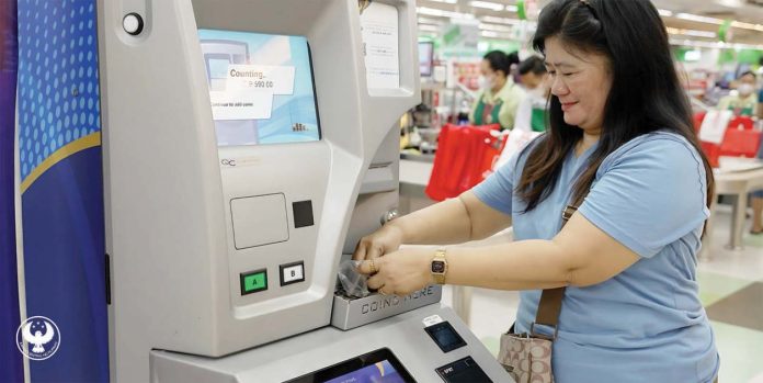 A woman deposited coins in a coin deposit machine in Metro Manila. The coins were directly credited to her electronic wallet. BSP PHOTO