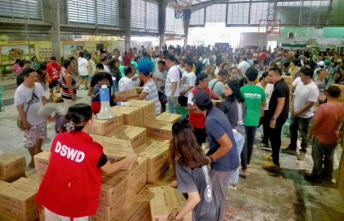 The Department of Social Welfare and Development distributes family food packs to disaster-affected residents in Dagupan City, Pangasinan. As of Sunday (Nov. 3), the government has already released aid amounting to P1.1 billion. Photo courtesy of DSWD-Ilocos