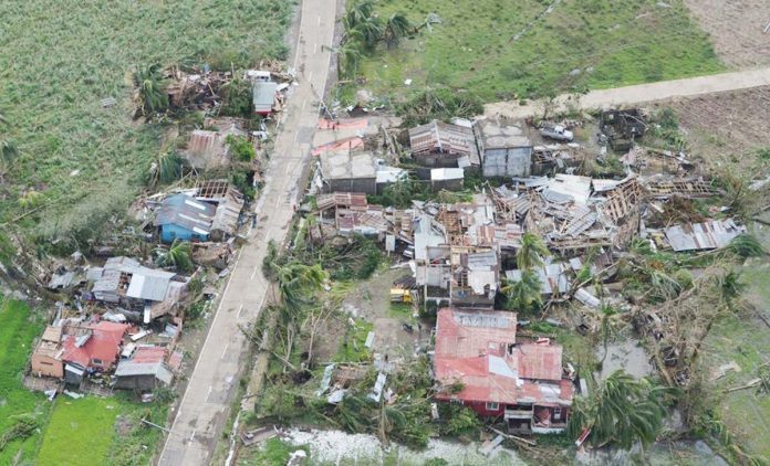 Damaged houses dot the national highway in Northern Iloilo after super typhoon Yolanda struck on November 8, 2013. Yolanda (international name: Haiyan) is considered one of the most destructive typhoons in history. PN