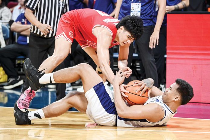 Adamson University Falcons’ Joshua Yerro and University of the East Red Warriors’ Wello Lingolingo battle for the loose ball. UAAP PHOTO