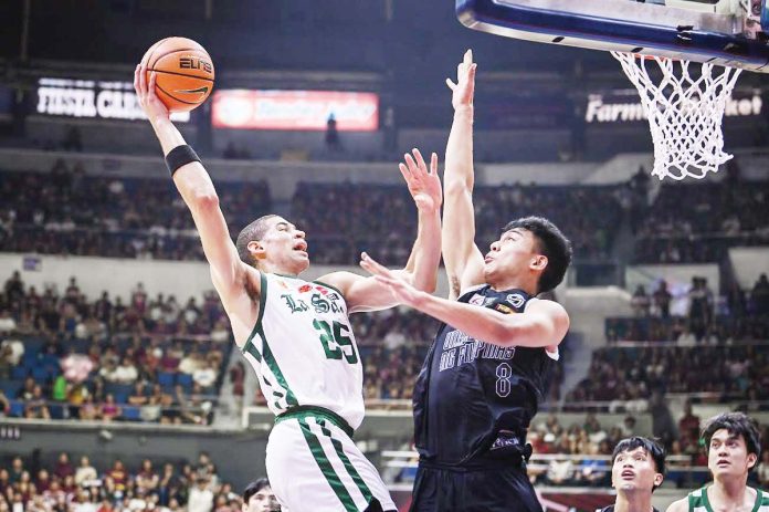 De La Salle University Green Archers’ Michael Phillips tries to score against the defense of University of the Philippines Fighting Maroons’ Jacob Bayla. UAAP PHOTO