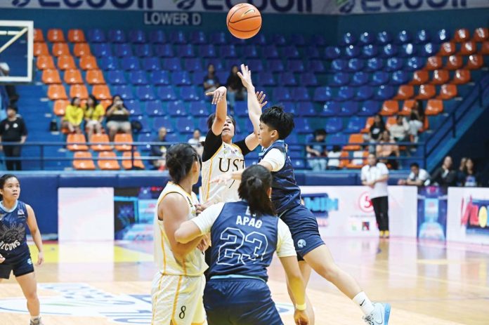 Ilongga Ana Tacatac of University of Santo Tomas Growling Tigresses attempts a three-pointer. UAAP PHOTO