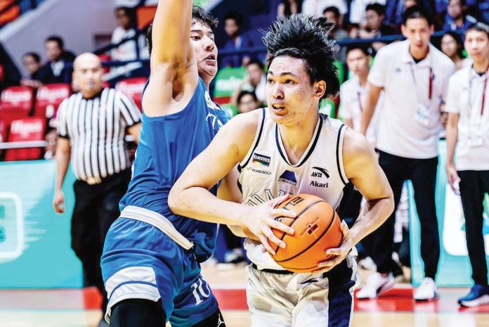 Adamson University Falcons’ Royce Mantua protects the ball from the defense of Ateneo de Manila University Blue Eagles’ Shawn Tuano. UAAP PHOTO