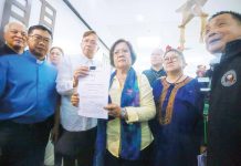 Former senator and Justice secretary Leila de Lima (holding paper) leads the filing of the first impeachment complaint against Vice President Sara Z. Duterte at the House of Representatives in Quezon City on Monday (Dec. 2, 2024). The group cited culpable violation of the constitution, graft and corruption, bribery, and betrayal of public trust, among others. PNA photo by Joan Bondoc