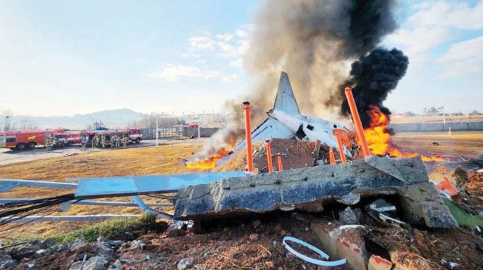 An ill-fated South Korean airplane burns after it crashed against a wall upon landing. BBC