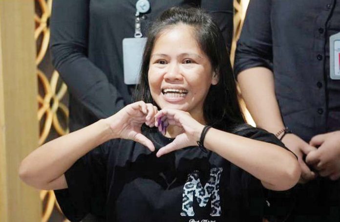 Mary Jane Veloso, who was on death row in Indonesia and was nearly executed by firing squad in 2015, makes a heart sign during a press conference before her repatriation to the Philippines, at Soekarno-Hatta International Airport in Tangerang, Indonesia on Dec. 17. AP