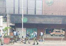 Operatives of the Bacolod City Police Office respond to a “robbery” at a financing institution on Araneta Street, Bacolod City on Saturday morning, Dec. 28, 2024. BCPO PHOTO