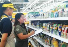 An inspector from the Department of Trade and Industry checks the prices of noche buena products at a supermarket in Iloilo City. DTI REGION 6 PHOTO