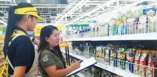 An inspector from the Department of Trade and Industry checks the prices of noche buena products at a supermarket in Iloilo City. DTI REGION 6 PHOTO