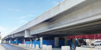 Safety barriers and protective coverings surround the repair site of the Ungka Flyover in Pavia, Iloilo, as concerns over falling debris prompt calls for tighter safety measures. The Department of Public Works and Highways - Region 6 is being urged to ensure public safety during the repair process. IME SORNITO/PN