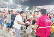 People dislocated by the eruption of Mount Kanlaon in Negros Occidental receive food packs from the Department of Social Welfare and Development - Region 6. Photo shows some of the evacuees at a covered gym in Barangay Robles, La Castellana, Negros Occidental. DSWD-6 PHOTO