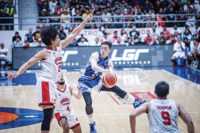 Hong Kong Eastern’s Chan Siu Wing looks to pass the ball after being defended by Barangay Ginebra San Miguel Kings’ Japeth Aguilar. PBA PHOTO