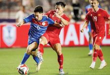 Philippine men’s football team’s Sandro Reyes tries to control the ball while being defended by a Vietnam player. GETTY IMAGES