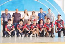 Antique National School principal Roger Jomolo and San Jose de Buenavista’s Mayor Justin Encarnacion (first and second from left) pose with the athletes after the distribution of uniforms on Tuesday, Dec. 3, 2024. PHOTO COURTESY OF MAYOR JUSTIN ENCARNACION