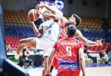 Converge FiberXers’ Deschon Winston is clobbered by the defense of Phoenix Fuel Masters’ Donovan Smith as he goes for an inside hit. PBA PHOTO