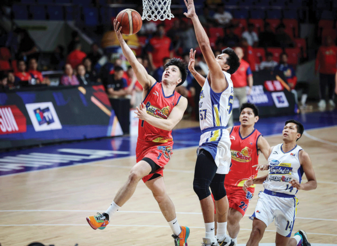 Rain or Shine Elasto Painters’ Adrian Nocum scores a layup against the defense of Magnolia Chicken Timplados Hotshots’ Andy Mark Barroca. PBA PHOTO