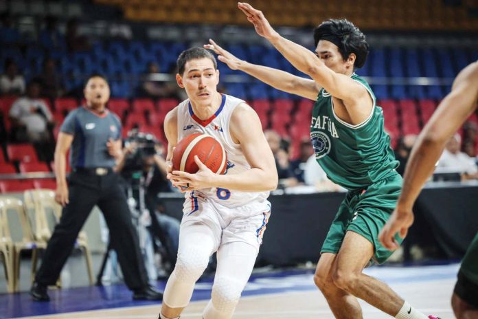 NLEX Road Warriors’ Robert Bolick Jr. protects the ball from the defense of Negrense guard Mark Nonoy of Terrafirma Dyip. PBA PHOTO