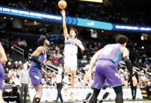 Washington Wizards’ Jordan Poole attempts a one-handed shot. AP