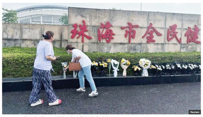 People placed flowers outside a stadium in Zhuhai after a car rampage that killed dozens. REUTERS