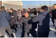 A policeman beats a protester with a baton in Pucheng, Shaanxi province in China during large-scale demonstrations. BBC