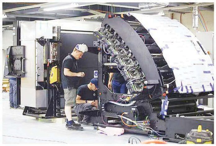 Technicians inspect a printing machine for ballots and other forms for the 2025 midterm polls at the National Printing Office in Quezon City. PNA