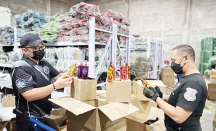 The Department of Finance’s Joint Administrative Order No. 23, or the Digital and Integrated System for Pre-border Technical Verification and Cross-border Electronic Invoicing, will go a long way in putting an end to smuggling, misdeclaration, and undervaluation. Photo shows Customs agents conducting an inspection of a warehouse in Valenzuela City where around P1.5 billion worth of smuggled goods and fake luxury items were seized. BUREAU OF CUSTOMS FILE PHOTO