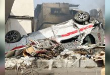 A damaged ambulance is seen upside down outside Kamal Adwan hospital in Beit Lahia, northern Gaza Strip. AFP