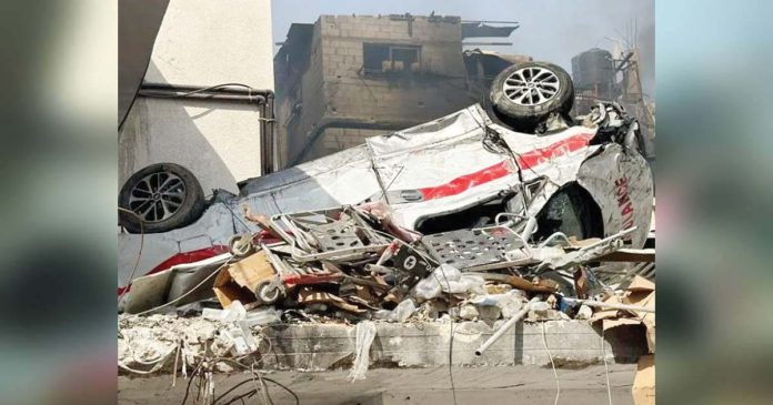 A damaged ambulance is seen upside down outside Kamal Adwan hospital in Beit Lahia, northern Gaza Strip. AFP