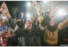 Palestinians celebrate the announcement of ceasefire deal in Deir al-Balah, central Gaza.