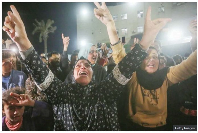 Palestinians celebrate the announcement of ceasefire deal in Deir al-Balah, central Gaza.