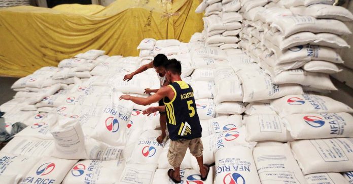 The National Food Authority (NFA) will purchase around 300,000 metric tons of rice this 2025 to cover 15 days of national consumption as mandated by the amended Rice Tariffication. Photo shows workers stacking rice at an NFA warehouse. INQUIRER FILE PHOTO