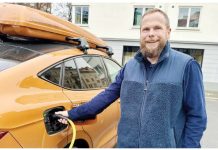 Norwegian motorist Ståle Fyen smiles as he attaches a charging cable to his electric car. Like a third of Norwegian motorists, Fyen now drives an electric car. BBC