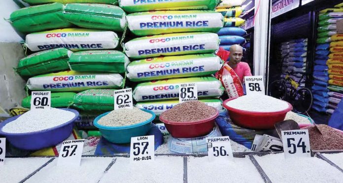 Rice vendor Eddie Pascual waits for customers at Marikina Public Market on Monday, Jan. 6, 2025. The Department of Agriculture says it will announce “very soon” the maximum suggested retail price for imported rice to help lower prices. INQUIRER.NET/GRIG C. MONTEGRANDE PHOTO