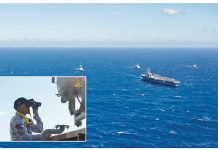 An officer of the Philippine Navy (inset) observes the nuclear-powered aircraft carrier USS Carl Vinson (CVN-70) sailing in formation, together with other vessels of the Philippine Navy and the US Navy, during a joint patrol or “maritime cooperative activity” off Palawan on January 17, 2025. PHOTOS FROM US NAVY AND PAOAFP