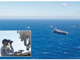 An officer of the Philippine Navy (inset) observes the nuclear-powered aircraft carrier USS Carl Vinson (CVN-70) sailing in formation, together with other vessels of the Philippine Navy and the US Navy, during a joint patrol or “maritime cooperative activity” off Palawan on January 17, 2025. PHOTOS FROM US NAVY AND PAOAFP