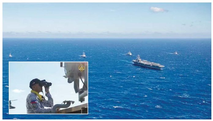 An officer of the Philippine Navy (inset) observes the nuclear-powered aircraft carrier USS Carl Vinson (CVN-70) sailing in formation, together with other vessels of the Philippine Navy and the US Navy, during a joint patrol or “maritime cooperative activity” off Palawan on January 17, 2025. PHOTOS FROM US NAVY AND PAOAFP