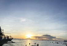 Tourists enjoy the beach and the sunset in Boracay Island.