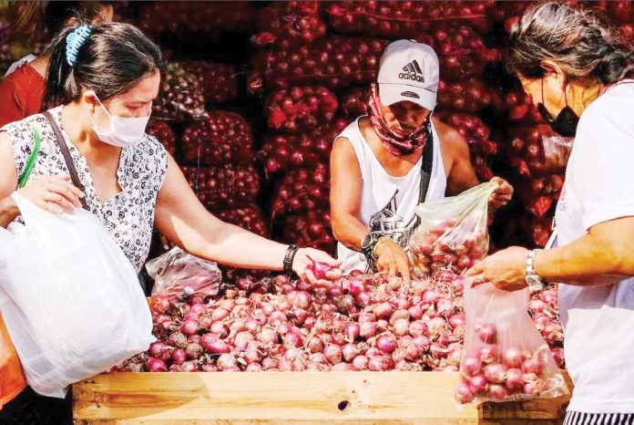 The Department of Agriculture says that improving the cold chain infrastructure will strengthen the agricultural sector, reduce farm losses, extend the shelf life of agricultural products, stabilize supply and prices, and ensure food security. Photo shows customers sifting through red onions at a stall in Divisoria market in Manila. GEORGE CALVELO, ABS-CBN NEWS/FILE